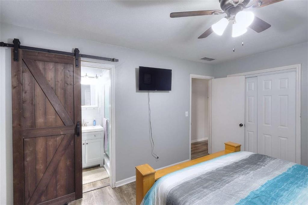 4455 Jersey Walnut Grove Road Covington, GA 30014 - Photo 20 of 28 a bedroom with a bed and a flat screen tv