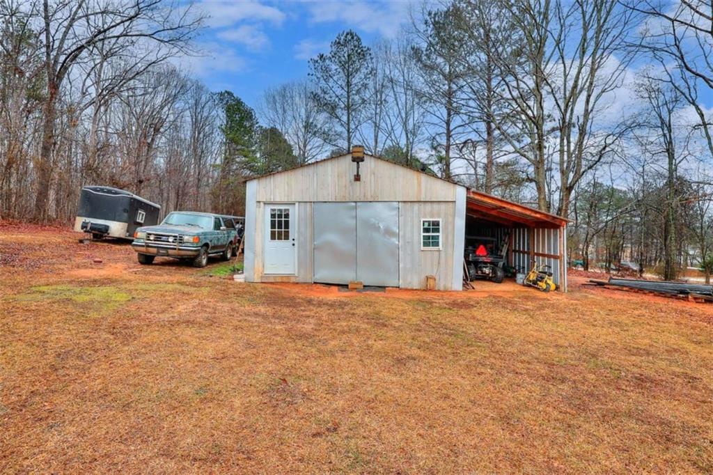 4455 Jersey Walnut Grove Road Covington, GA 30014 - Photo 25 of 28 a front view of a house with a yard and trees