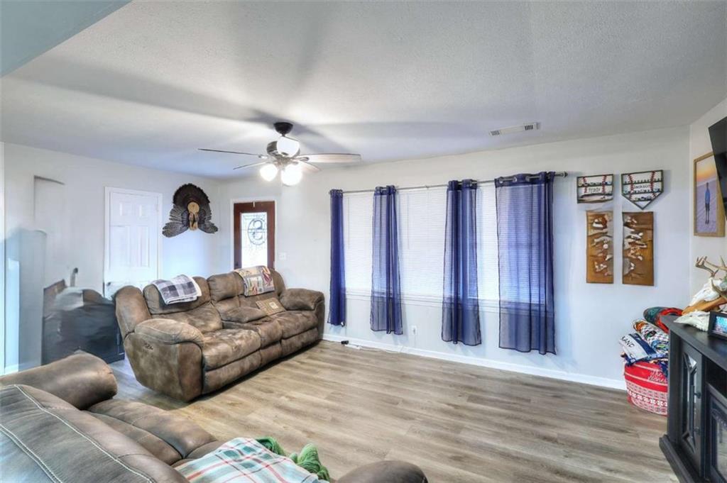 4455 Jersey Walnut Grove Road Covington, GA 30014 - Photo 7 of 28 a living room with furniture and a chandelier