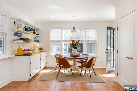 a dining room with furniture and a window