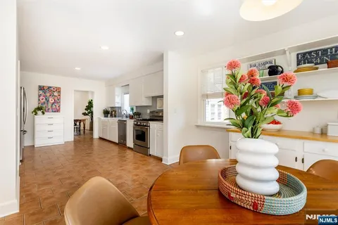 a living room with furniture and flowers