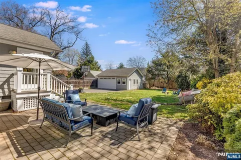 a view of a house with backyard and sitting area