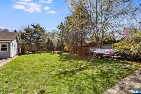 a backyard of a house with table and chairs