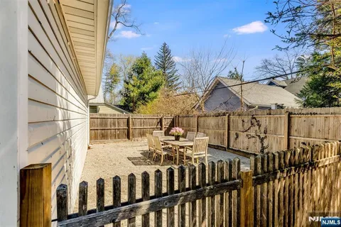 a view of a house with wooden fence