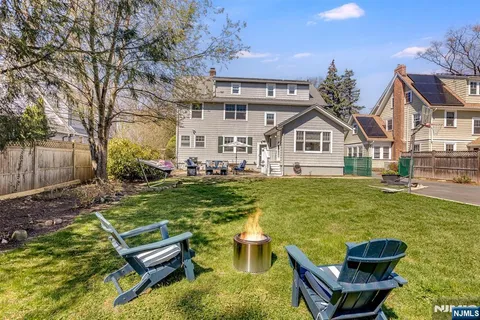 a view of a house with pool and chairs