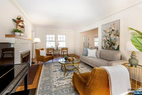 a living room with furniture fireplace and window
