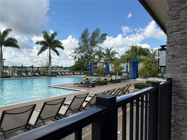 a view of a swimming pool with outdoor seating