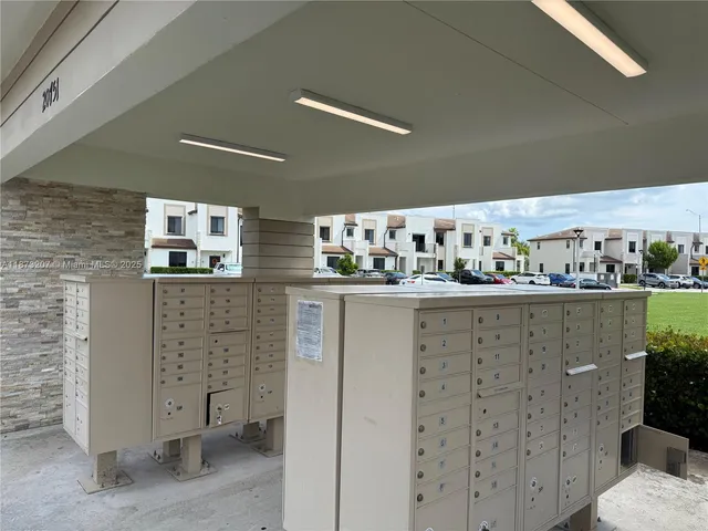 a view of a balcony with chairs and wooden fence
