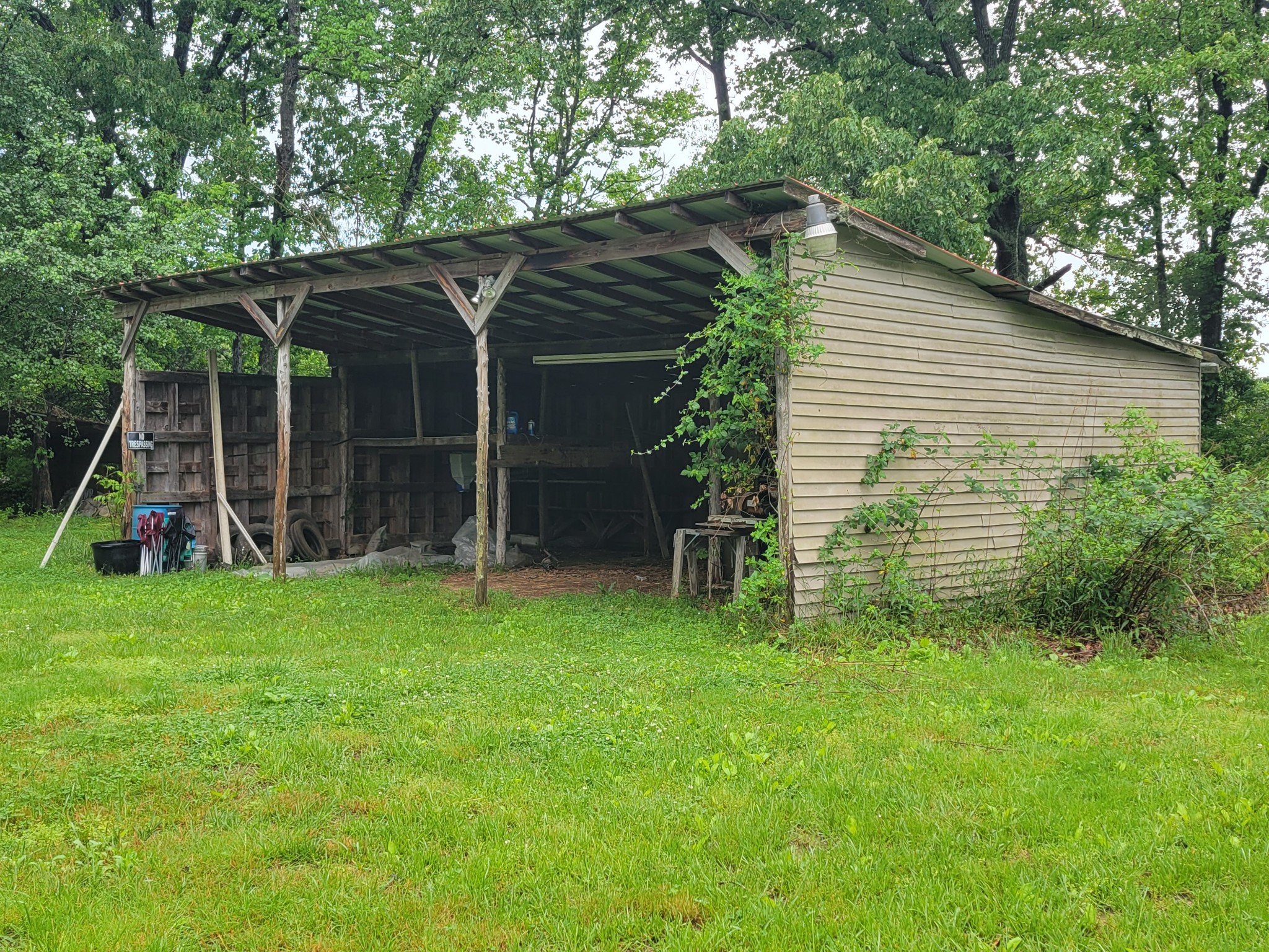 132 Gruett Road Manchester, TN 37355 - Photo 32 of 36 a backyard of a house with plants and wooden fence