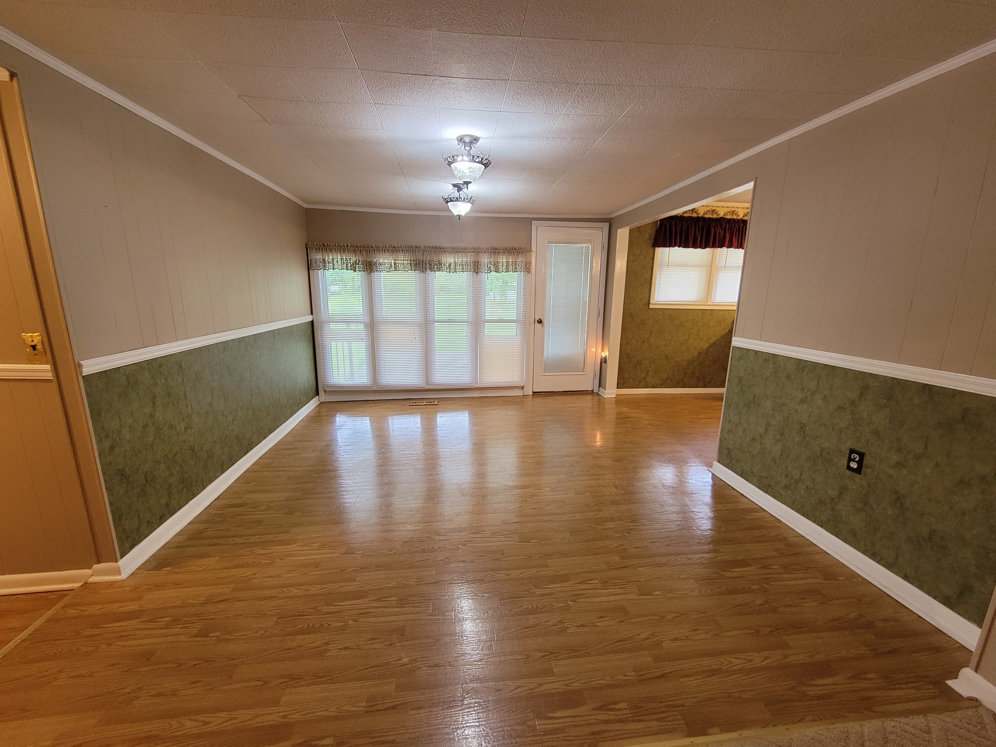 132 Gruett Road Manchester, TN 37355 - Photo 5 of 36 a view of an empty room with wooden floor and a window