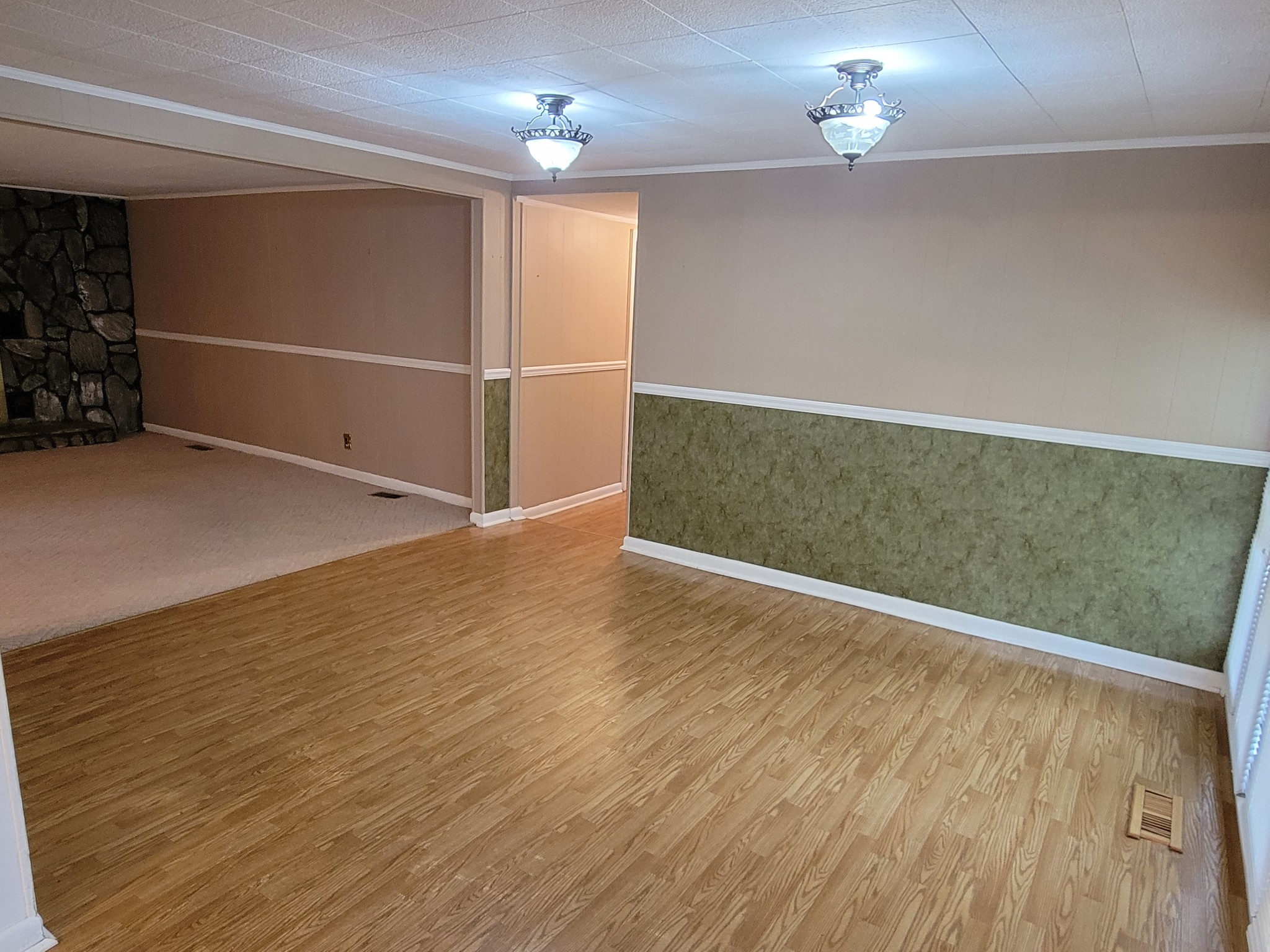 132 Gruett Road Manchester, TN 37355 - Photo 6 of 36 an empty room with wooden floor and windows