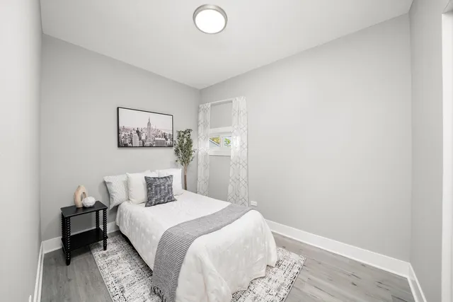 a bedroom with a bed and a wooden floor