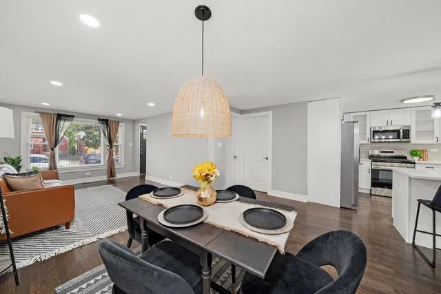 a dining room with furniture and wooden floor