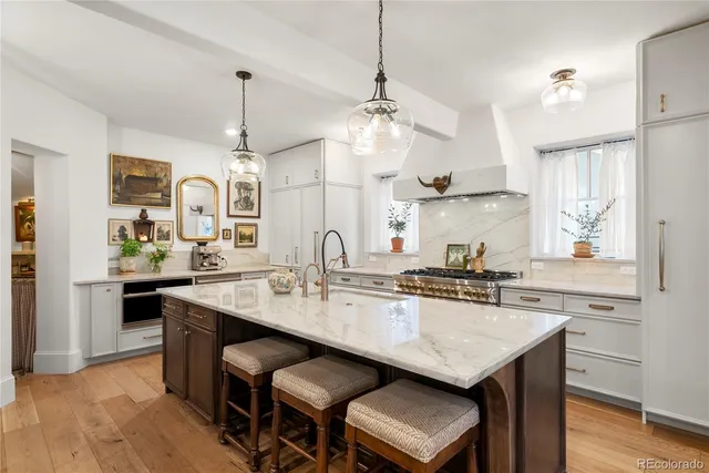 a kitchen with center island table and chairs in it