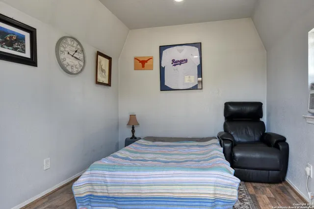 a bedroom with a bed and painting on the wall