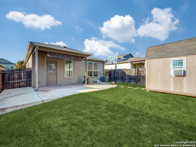 a front view of a house with a garden and plants