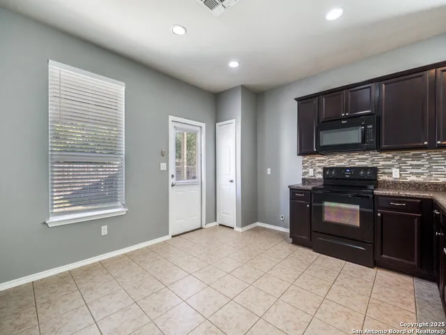 a kitchen with stainless steel appliances granite countertop a stove and a sink