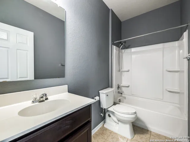 a bathroom with a sink toilet vanity and shower