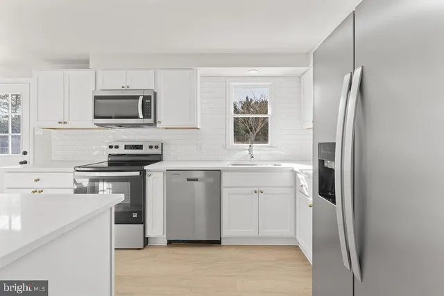 a kitchen with a refrigerator stove and sink
