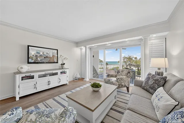 a living room with furniture and a painting on the wall