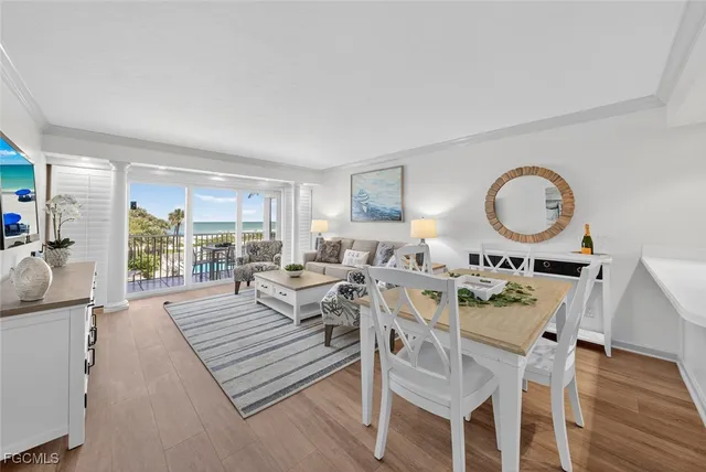 a view of a livingroom with furniture window and wooden floor