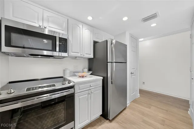 a kitchen with a stove microwave and refrigerator