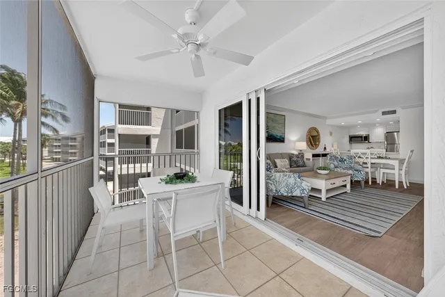 a living room with furniture a rug and white walls