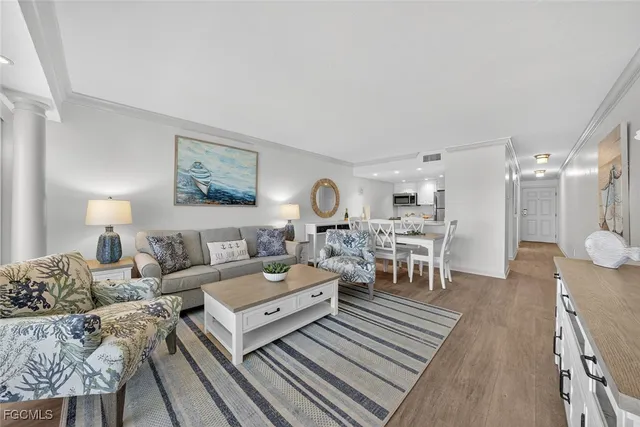 a living room with lots of furniture and painting on the wall