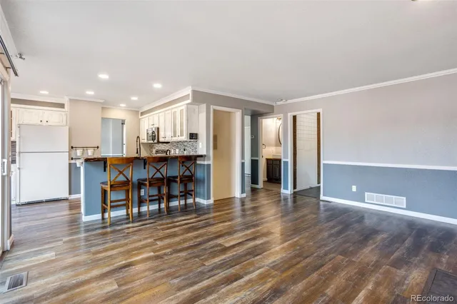 a view of a kitchen with dining room and wooden floor