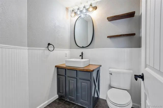 a bathroom with a toilet a sink and mirror
