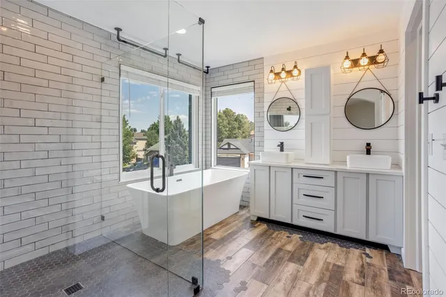 a bathroom with a granite countertop sink mirror and toilet