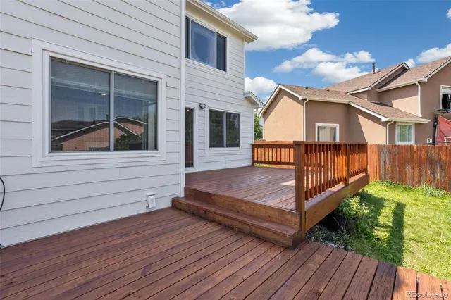 a view of a house with a wooden deck