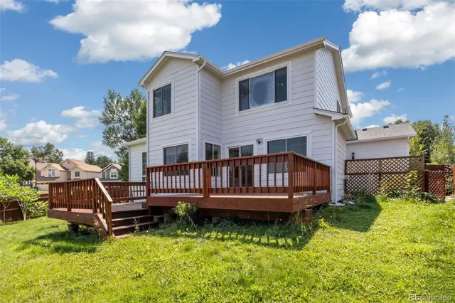 a view of a house with a backyard and sitting area