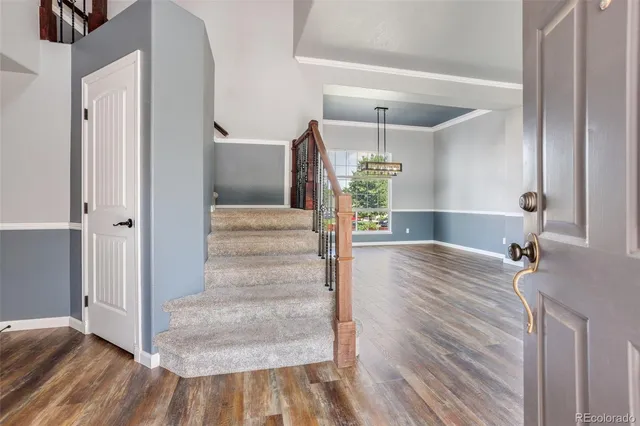 a view of a hallway view with wooden floor and staircase