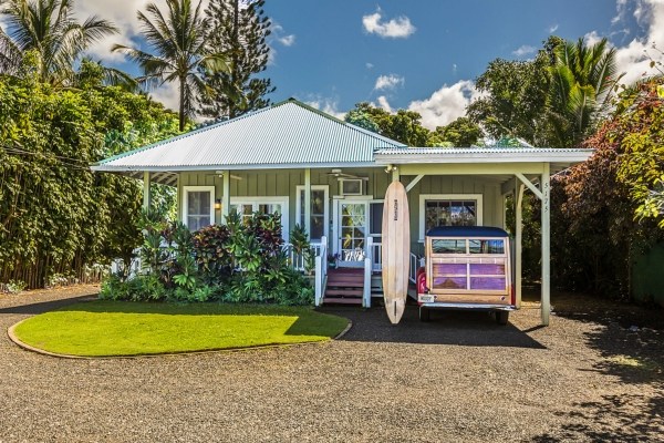 a view of a house with a swimming pool and a yard
