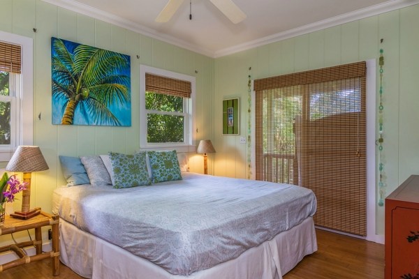 5175 Weke Road Hanalei, HI 96714 - Photo 18 of 25 a bedroom with a bed and a painting on the wall
