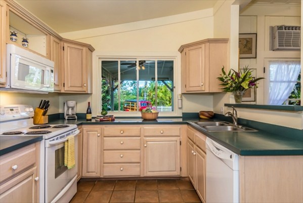 5175 Weke Road Hanalei, HI 96714 - Photo 7 of 25 a kitchen with granite countertop a sink stove and cabinets