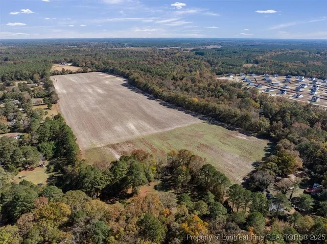 an aerial view of a houses with a yard