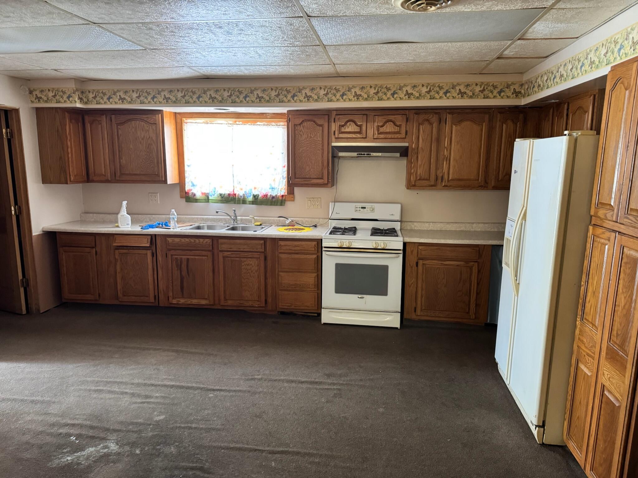 1900 West Old Ridge Road Hobart, IN 46342 - Photo 4 of 11 a kitchen with stainless steel appliances granite countertop a stove a sink and a refrigerator