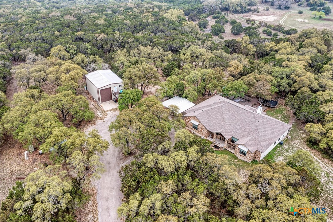 1325 County Road 106 Lampasas, TX 76550 - Photo 18 of 48 an aerial view of a house with a yard and trees