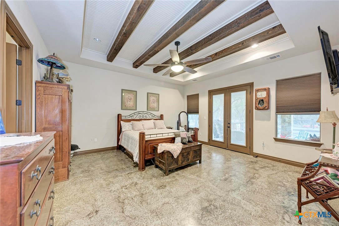 1325 County Road 106 Lampasas, TX 76550 - Photo 21 of 48 a spacious bedroom with a bed and large windows