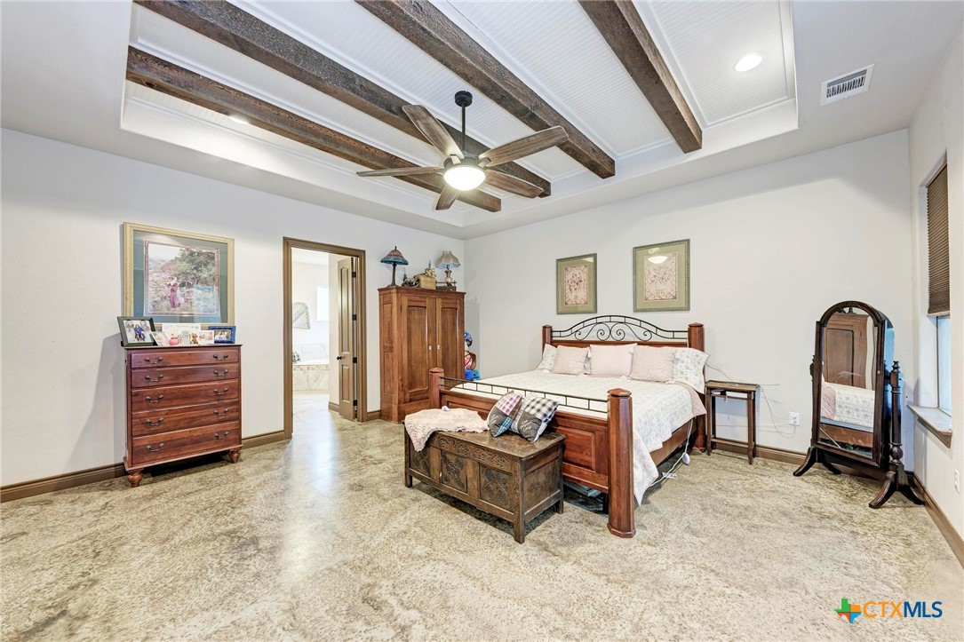 1325 County Road 106 Lampasas, TX 76550 - Photo 22 of 48 a spacious bedroom with a bed and a dresser