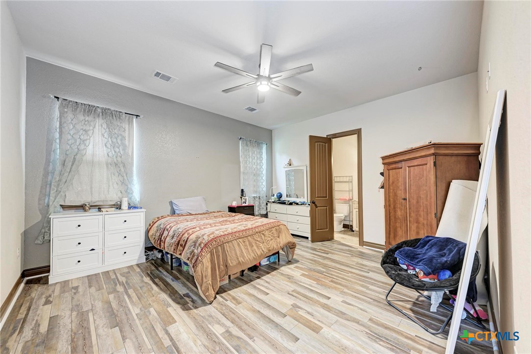 1325 County Road 106 Lampasas, TX 76550 - Photo 32 of 48 a bedroom with a bed and a dresser in it