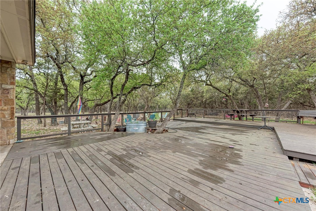 1325 County Road 106 Lampasas, TX 76550 - Photo 41 of 48 a view of a yard with wooden floor and large trees