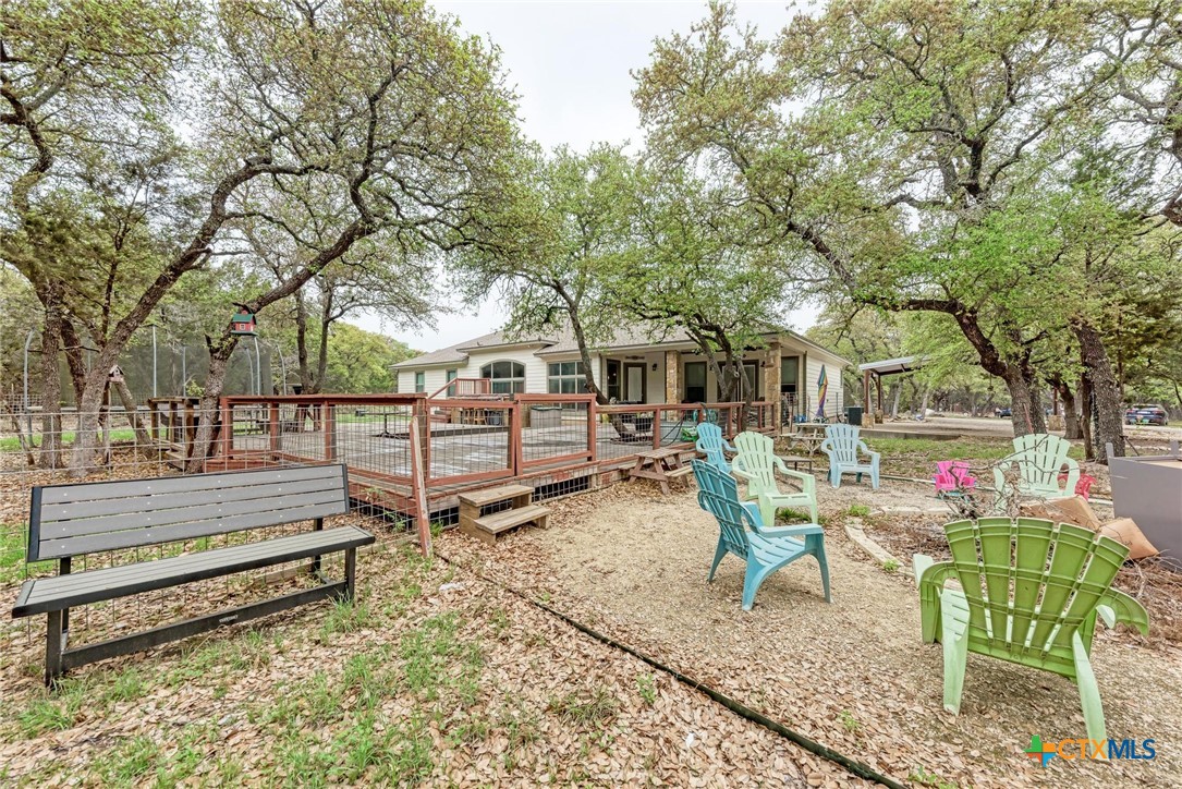 1325 County Road 106 Lampasas, TX 76550 - Photo 44 of 48 a view of backyard with a table and chairs a couches and a large tree