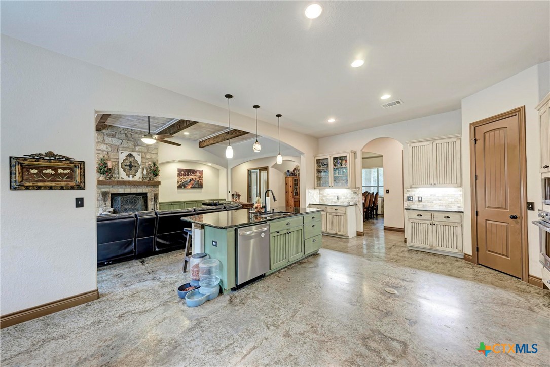 1325 County Road 106 Lampasas, TX 76550 - Photo 7 of 48 a kitchen with stainless steel appliances granite countertop a stove and cabinets