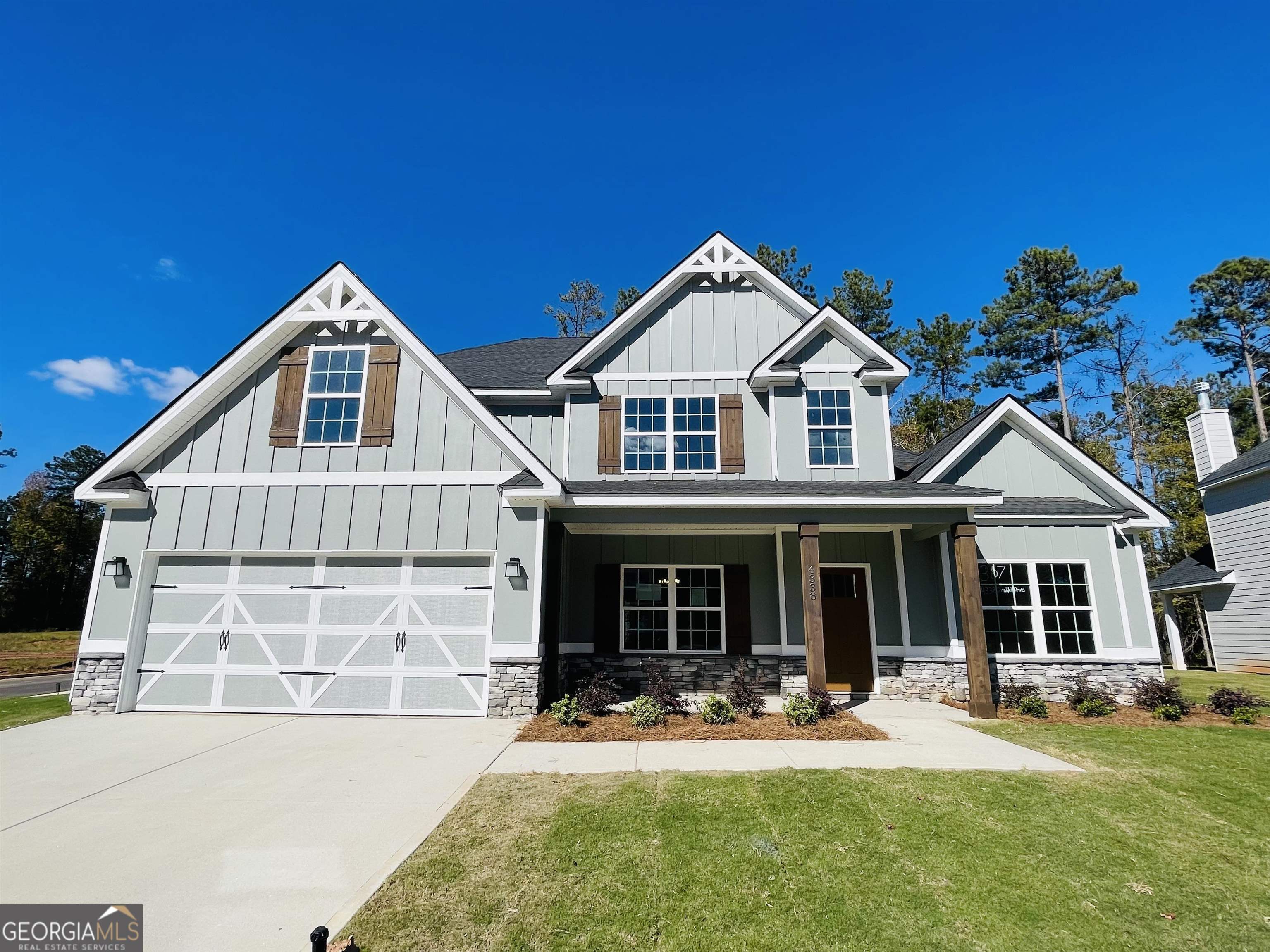 a front view of a house with a yard and porch