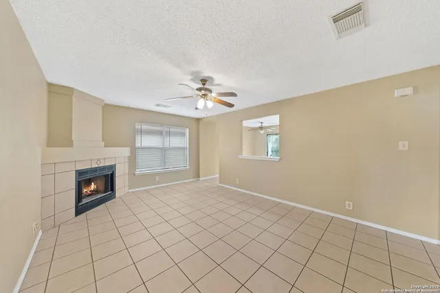 a view of an empty room with a fireplace