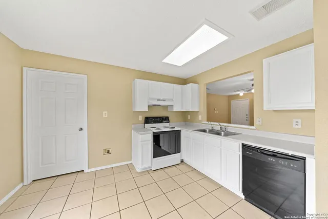 a kitchen with stainless steel appliances granite countertop a stove and a sink