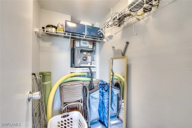 a view of walk in closet with clothes